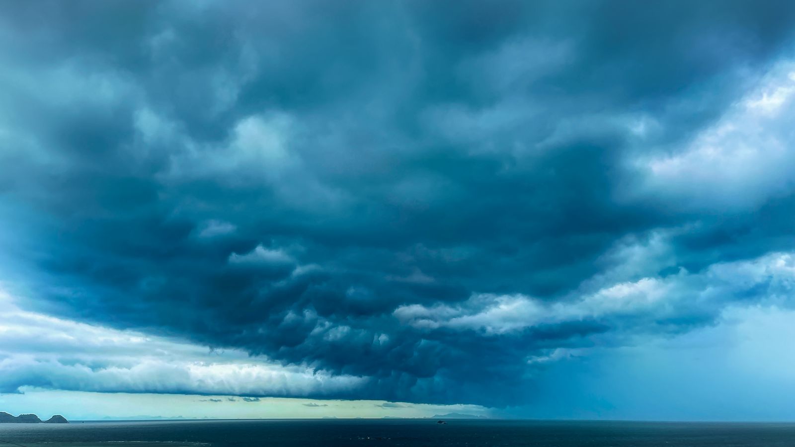A dark storm front moving in over open Gulf water
